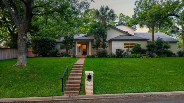 a front view of a house with a yard