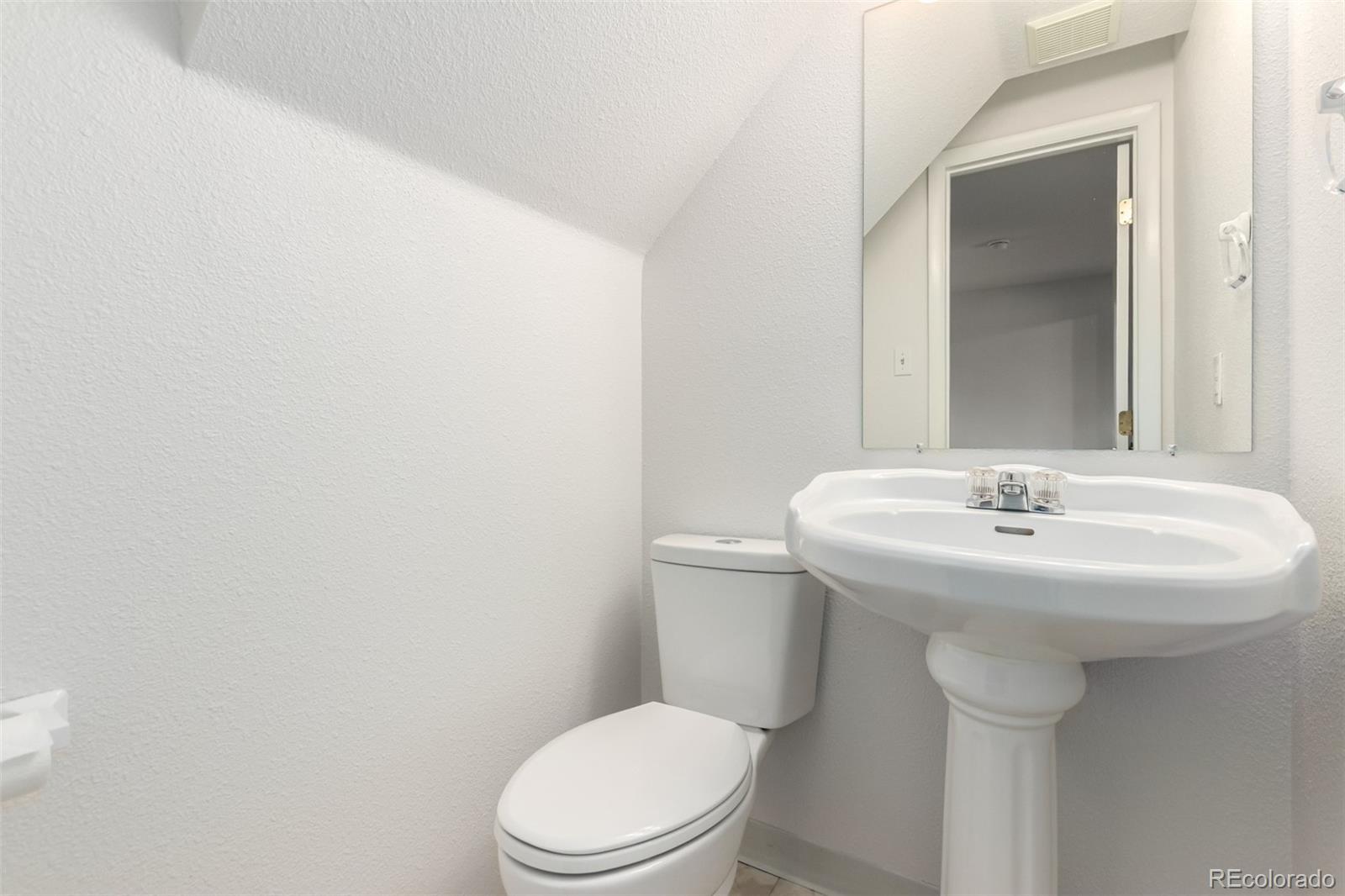 8976 West 46th Place, Unit 8976 Wheat Ridge, CO 80033 - Photo 5 of 10 a bathroom with a sink a toilet
