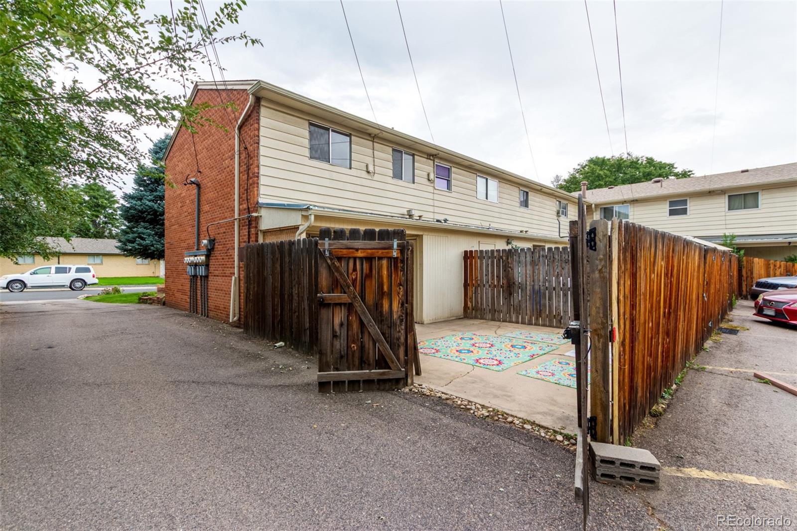 8976 West 46th Place, Unit 8976 Wheat Ridge, CO 80033 - Photo 8 of 10 a view of a house with wooden fence