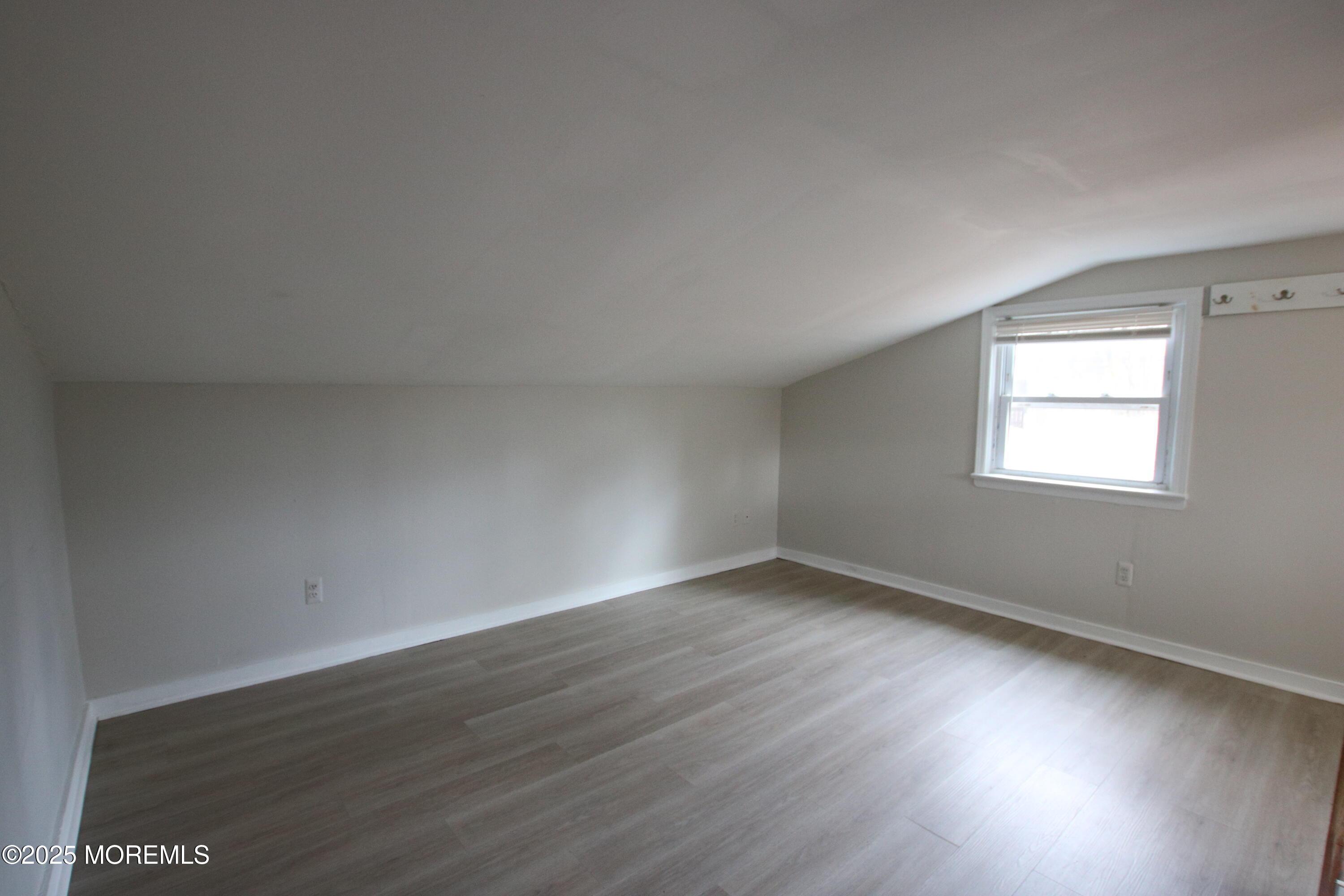 58 Monmouth Road Eatontown, NJ 07724 - Photo 24 of 32 an empty room with wooden floor and windows