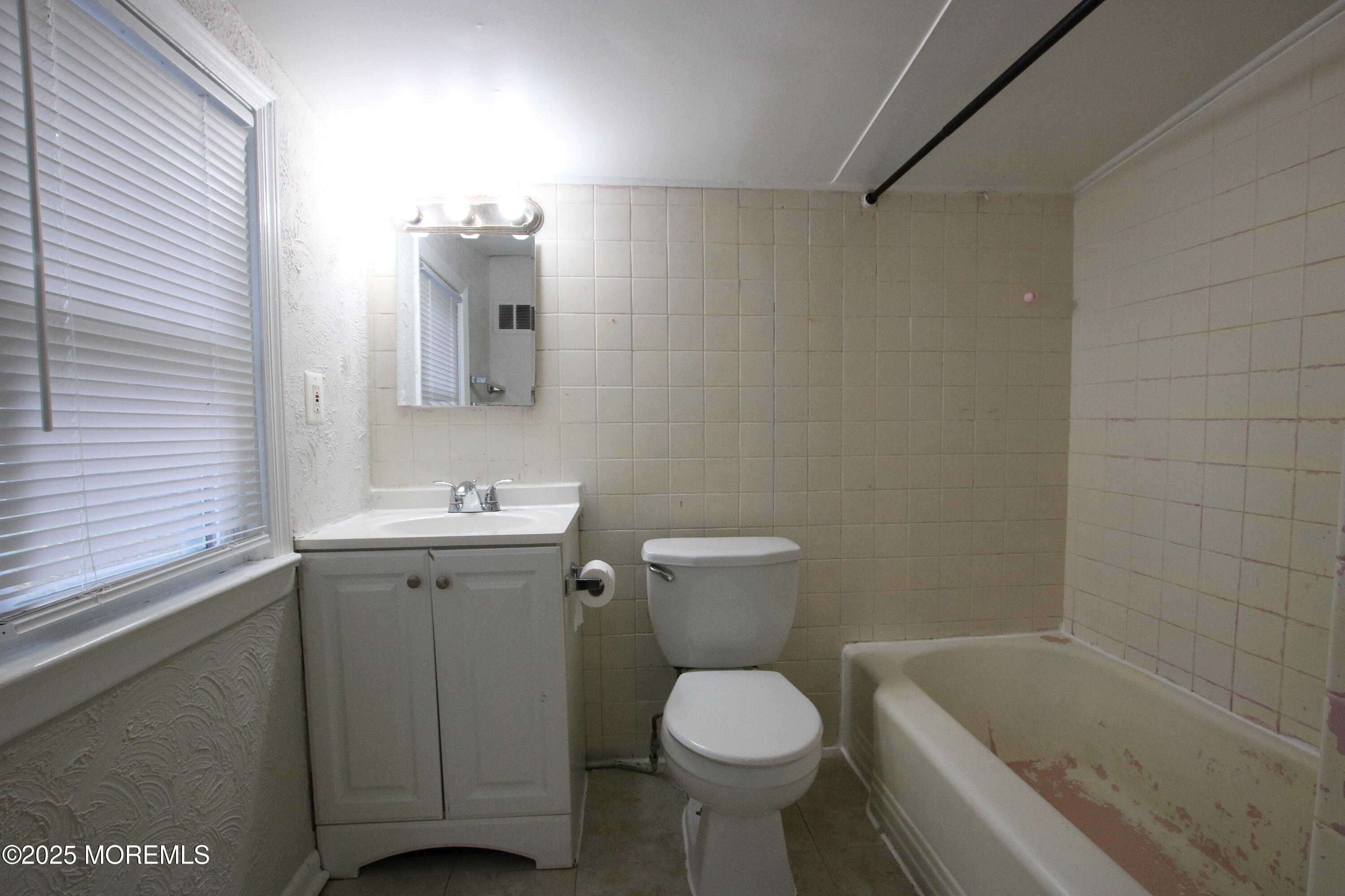 58 Monmouth Road Eatontown, NJ 07724 - Photo 27 of 32 a bathroom with a sink toilet and shower