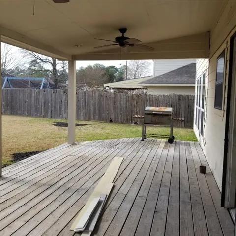 a view of a deck with wooden floor and outdoor seating