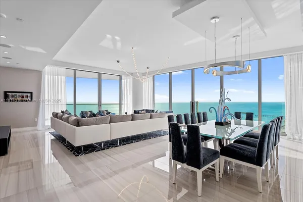 a living room with furniture and large windows