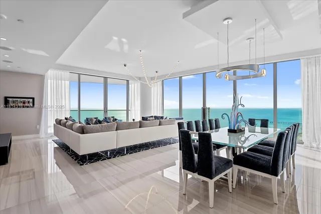 a living room with furniture and large windows