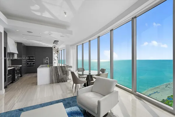 a living room with furniture and large windows