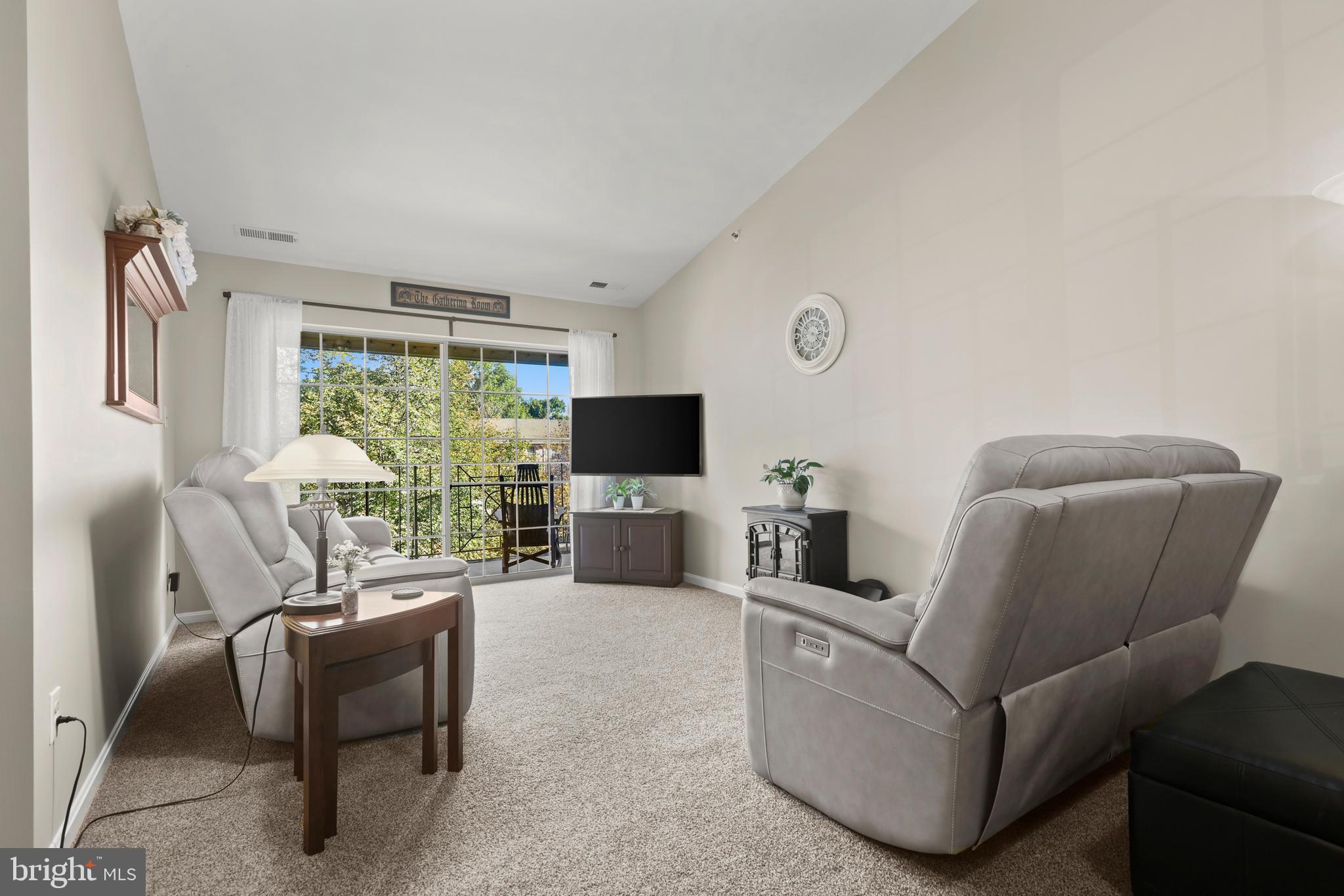 3506 Back Pointe Court, Unit 3D Abingdon, MD 21009 - Photo 5 of 33 a living room with furniture a flat screen tv and a large window