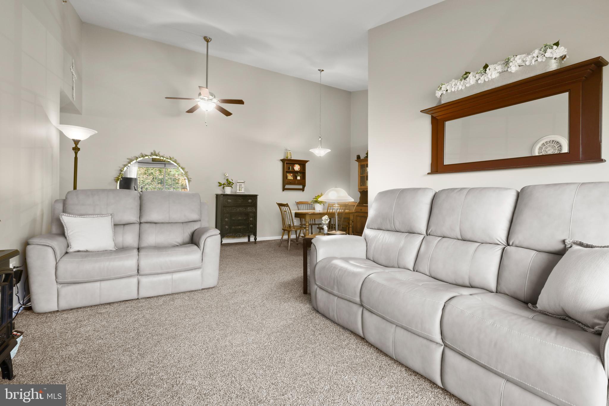 3506 Back Pointe Court, Unit 3D Abingdon, MD 21009 - Photo 7 of 33 a living room with furniture a ceiling fan and a rug