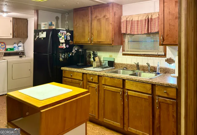 a kitchen with stainless steel appliances a refrigerator sink and cabinets
