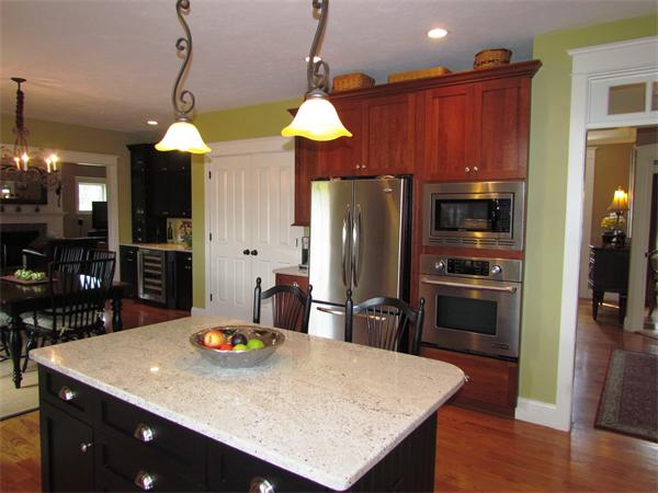 50 Adams Road Grafton, MA 01536 - Photo 7 of 30 a kitchen with stainless steel appliances wooden floor dining table and chairs