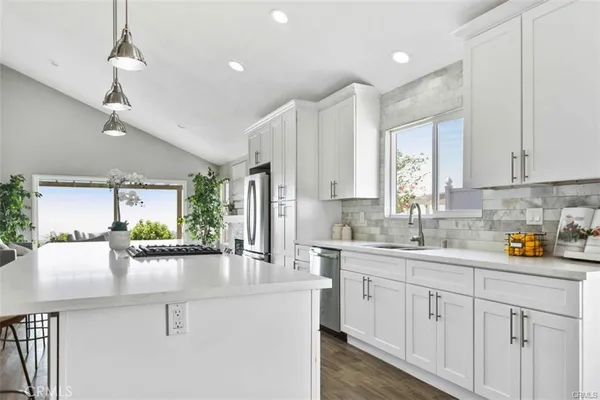 a kitchen with a sink stove and cabinets