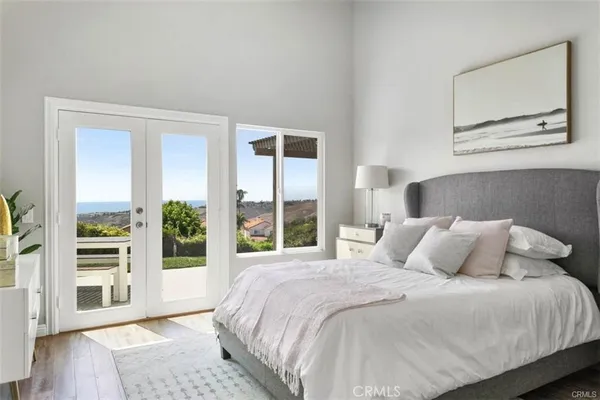 a bedroom with a large bed and a large window