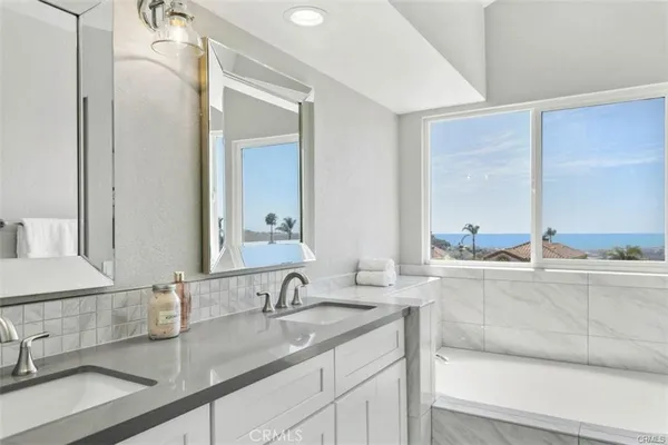 a bathroom with a double vanity sink and mirror