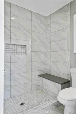 a bathroom with a toilet and a shower