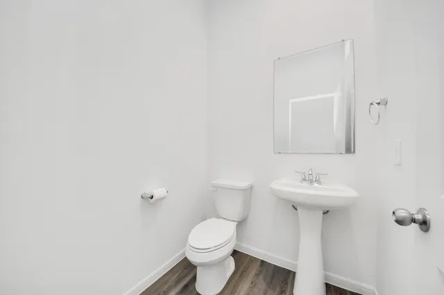 a bathroom with a sink toilet and mirror