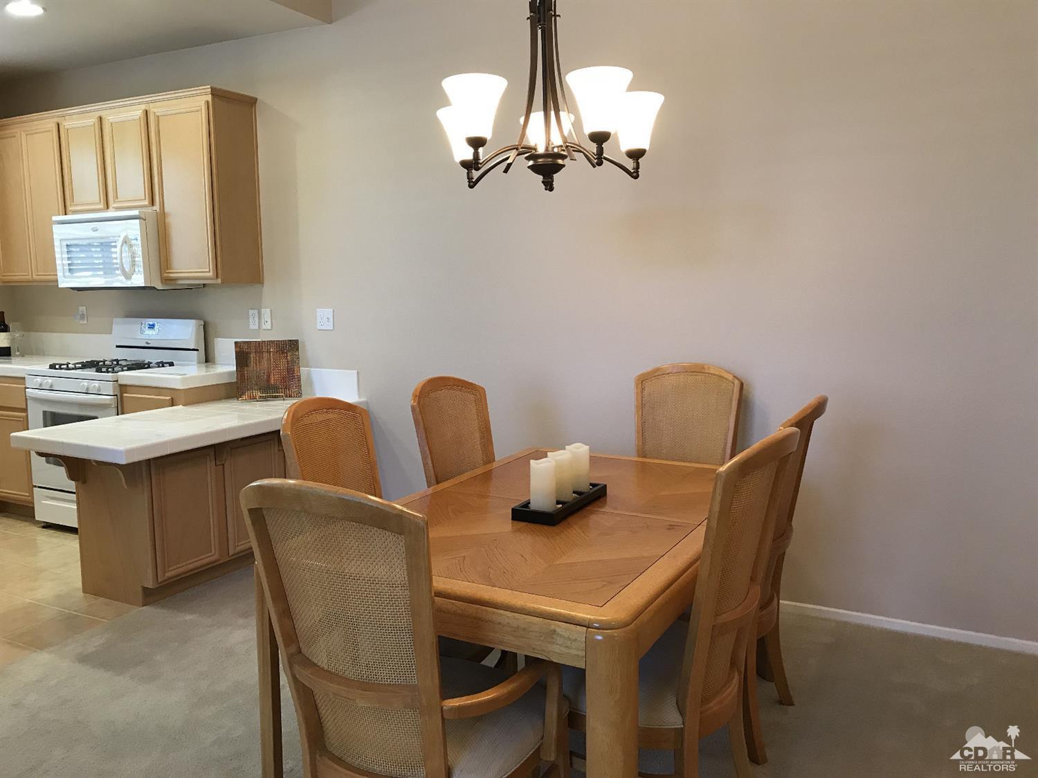 47848 Dancing Butterfly La Quinta, CA 92253 - Photo 12 of 36 a dining room with furniture and chandelier