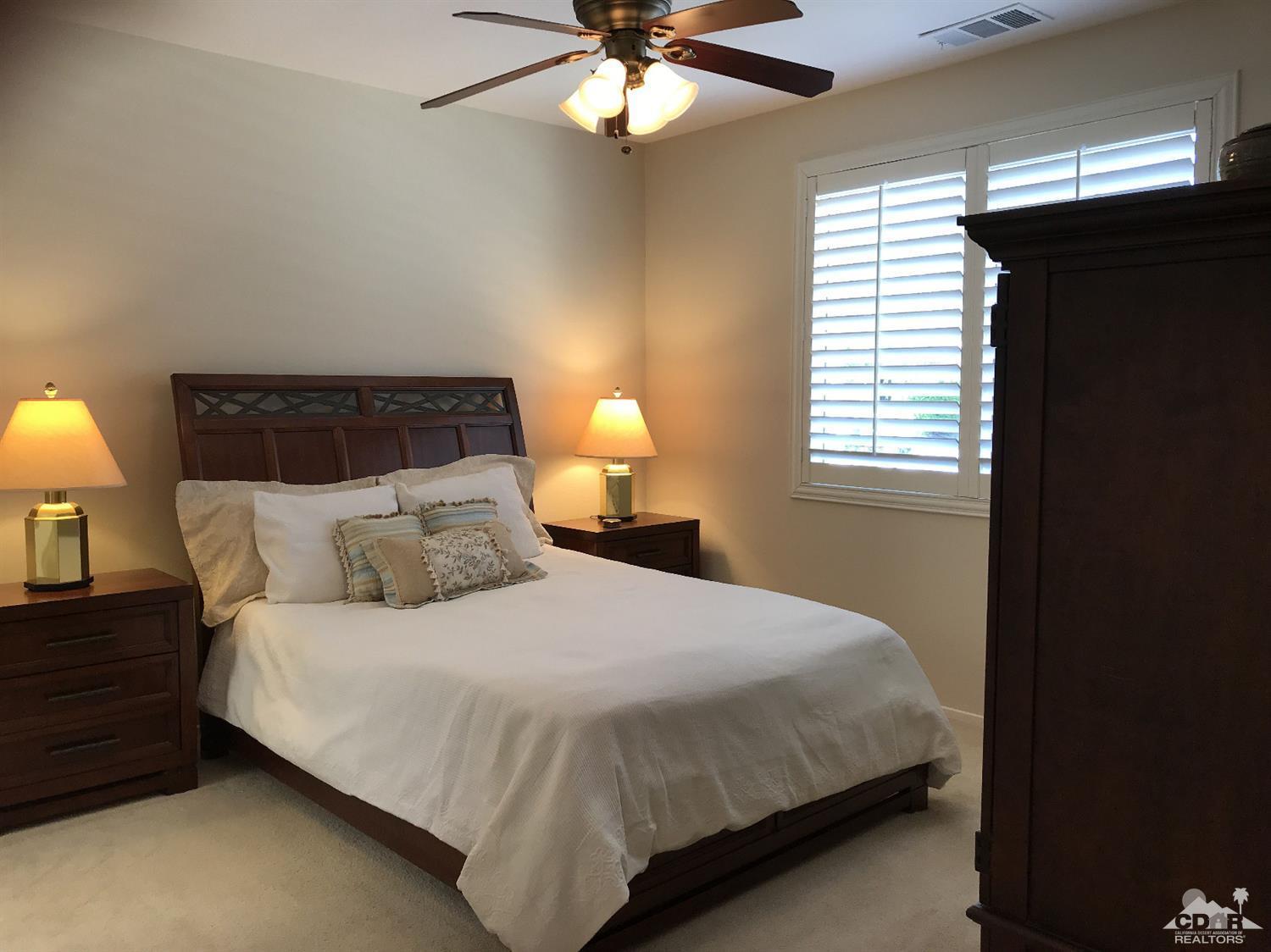 47848 Dancing Butterfly La Quinta, CA 92253 - Photo 15 of 36 a bedroom with a bed and a window