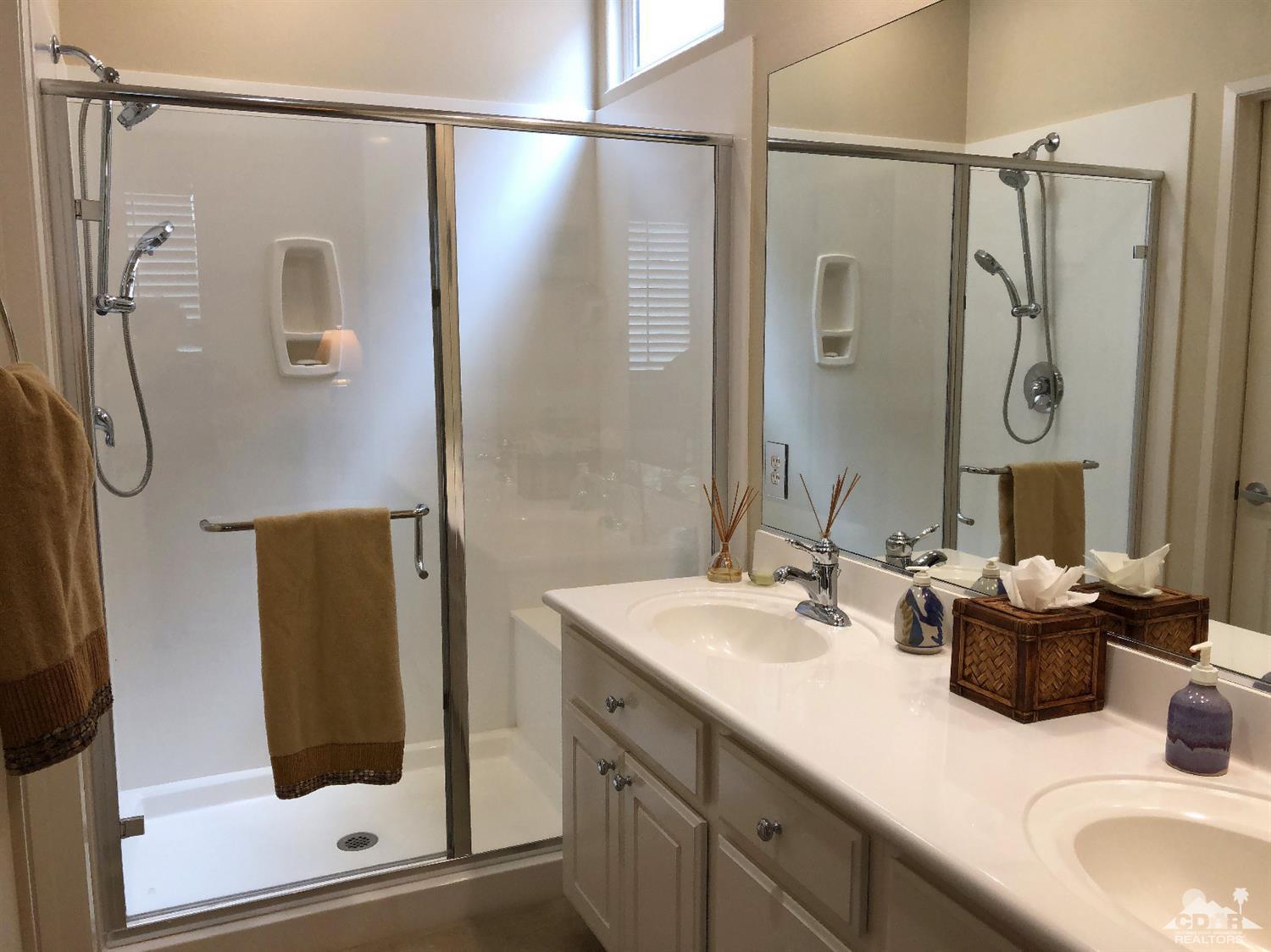 47848 Dancing Butterfly La Quinta, CA 92253 - Photo 17 of 36 a bathroom with a granite countertop shower sink and mirror
