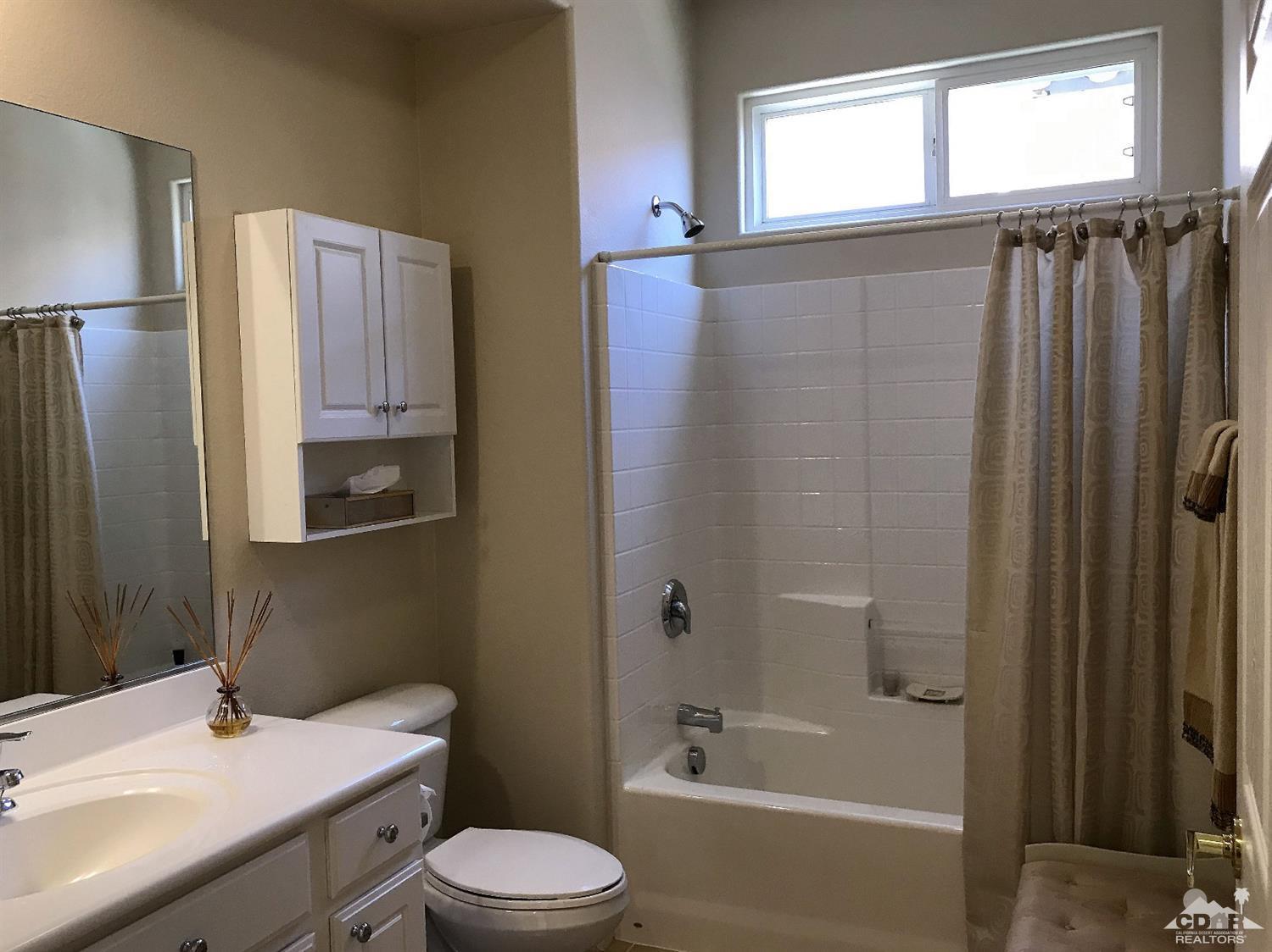 47848 Dancing Butterfly La Quinta, CA 92253 - Photo 19 of 36 a bathroom with a sink toilet and shower