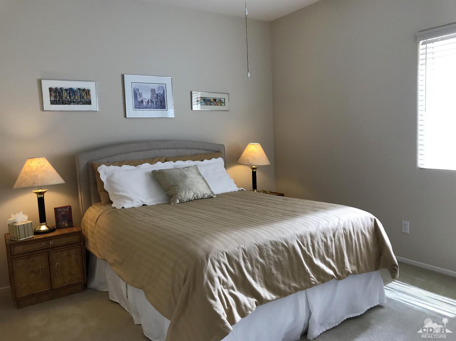 47848 Dancing Butterfly La Quinta, CA 92253 - Photo 21 of 36 a bedroom with a bed and lamp