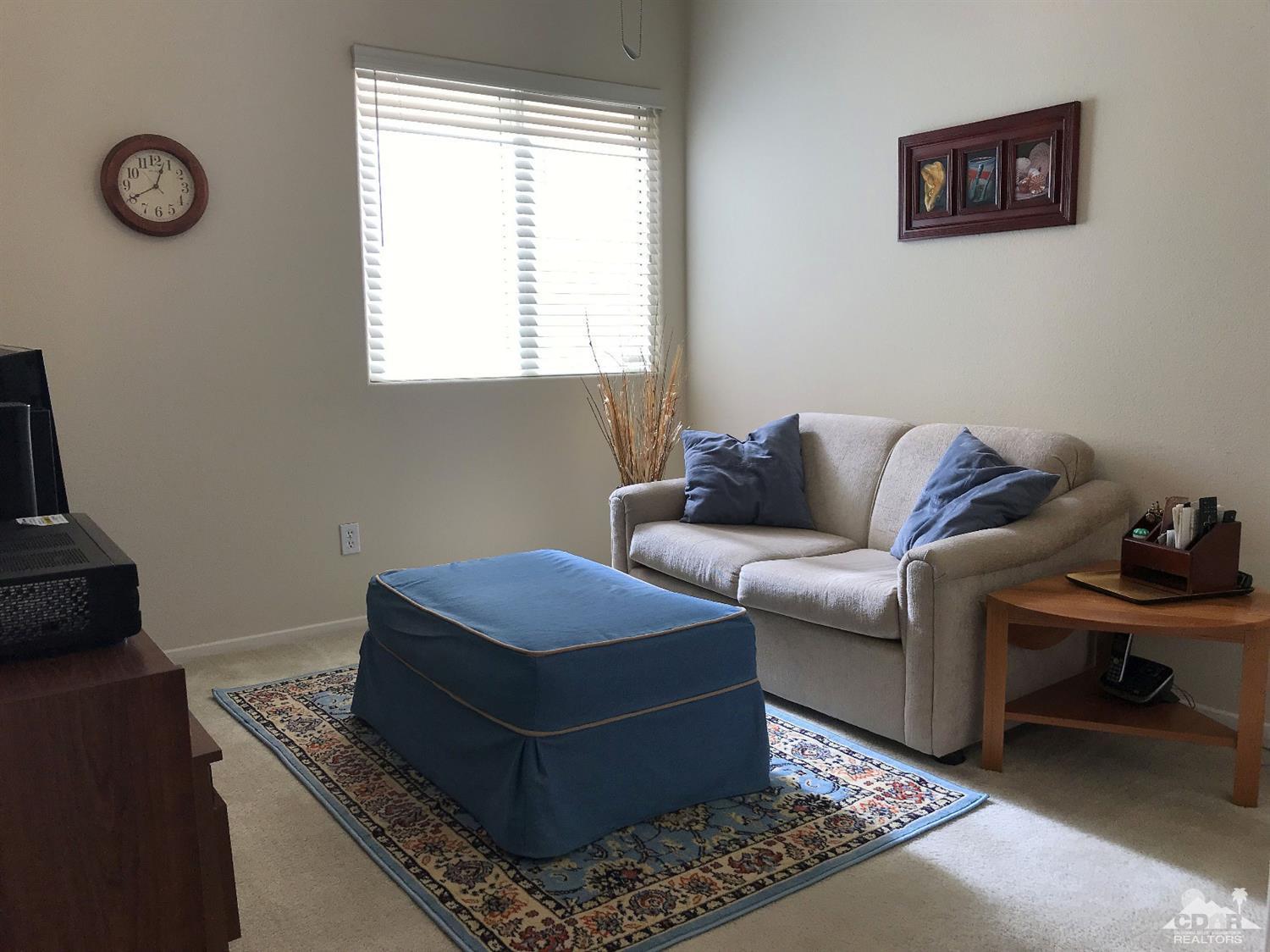 47848 Dancing Butterfly La Quinta, CA 92253 - Photo 23 of 36 a living room with furniture and a window