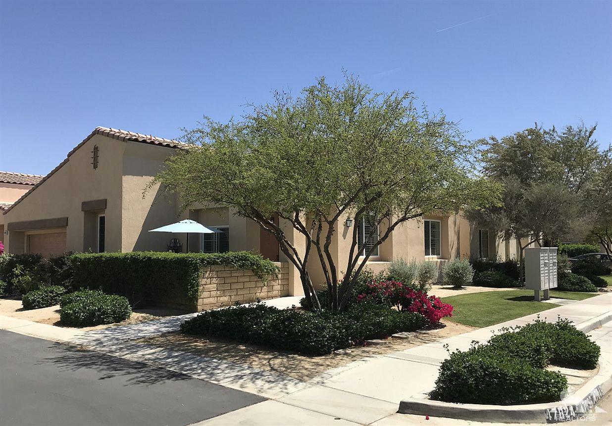 47848 Dancing Butterfly La Quinta, CA 92253 - Photo 24 of 36 a front view of a house with a yard and potted plants