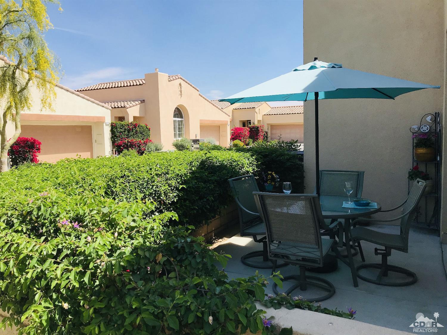 47848 Dancing Butterfly La Quinta, CA 92253 - Photo 26 of 36 a front view of a house with porch and garden