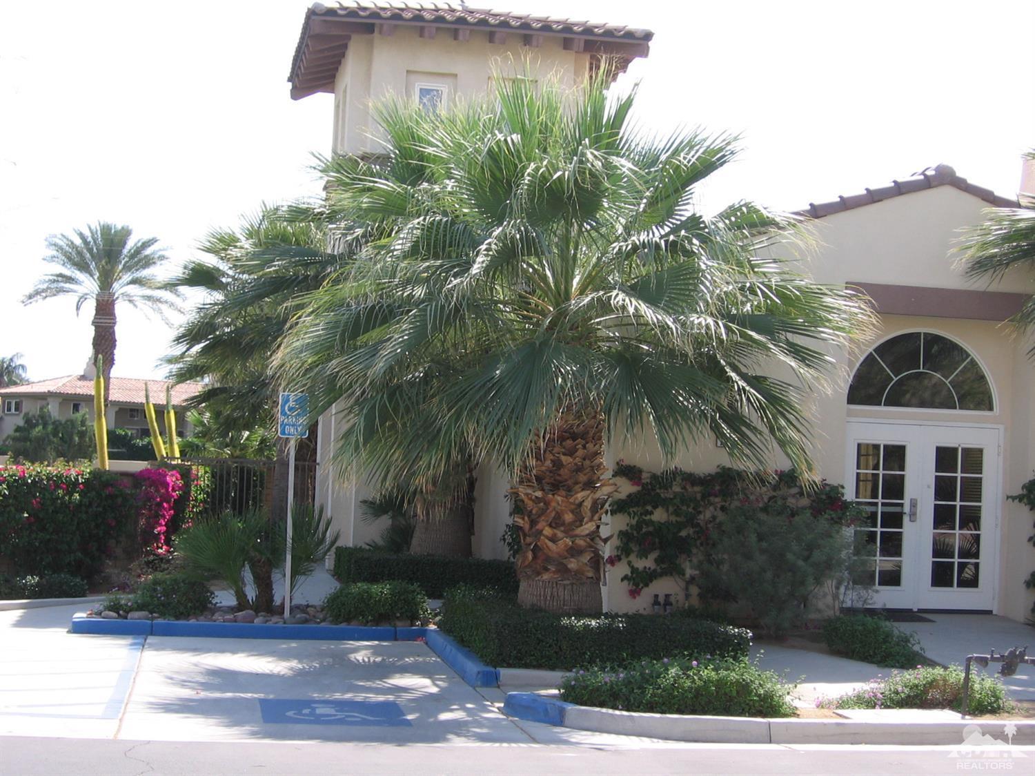 47848 Dancing Butterfly La Quinta, CA 92253 - Photo 28 of 36 a front view of house with yard and green space