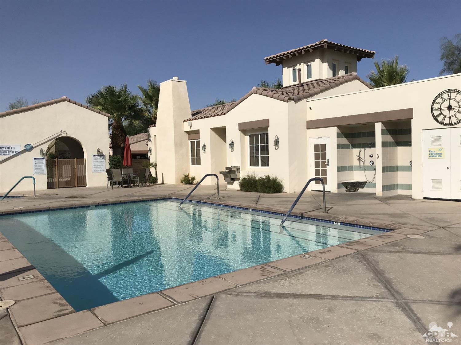 47848 Dancing Butterfly La Quinta, CA 92253 - Photo 31 of 36 a view of a house with large windows and a table