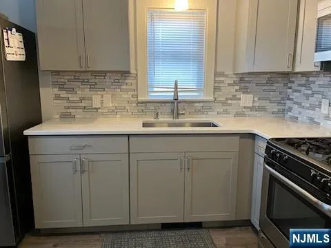 a kitchen with a sink stove and cabinets