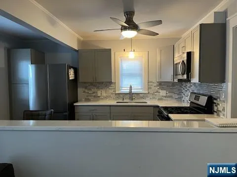 a bathroom with a sink a large mirror and a shower