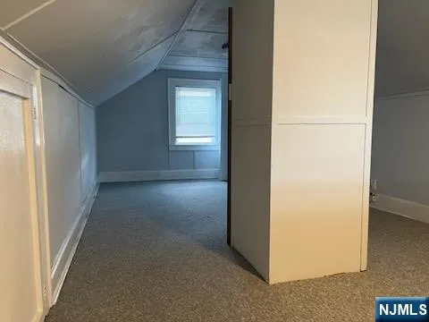 a view of a hallway to rooms