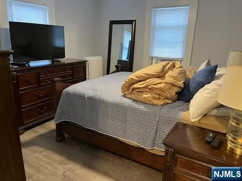 a bedroom with a bed and flat screen tv