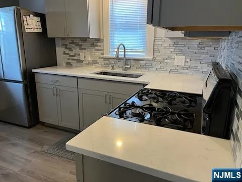 a kitchen with a sink a stove and refrigerator