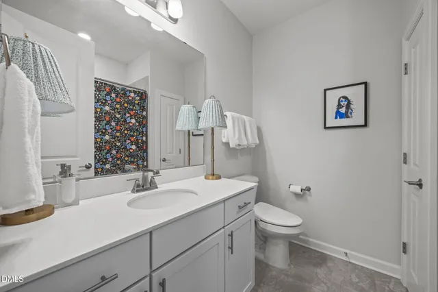 an empty room with ceiling fan and windows