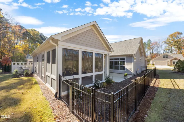 a view of a patio with lawn chairs