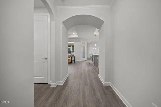 a large kitchen with kitchen island a dining table chairs and a refrigerator