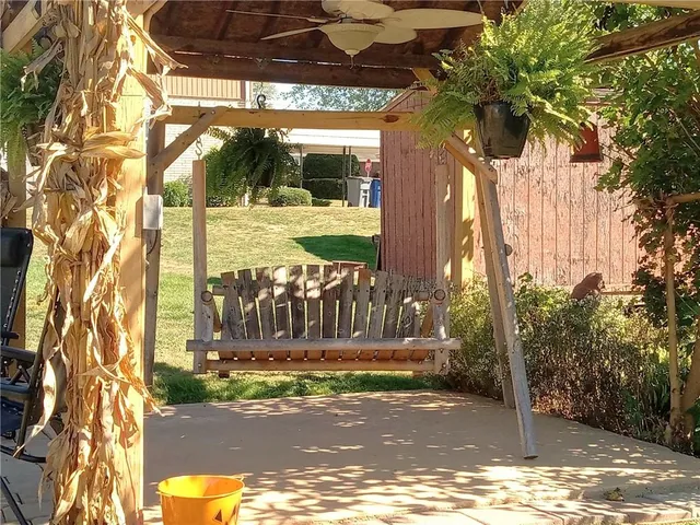 a view of a entrance gate of the house and trees