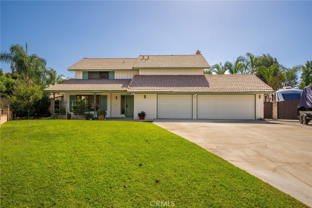 2330 Peppertree Lane Riverside, CA 92506 - Photo 1 of 1 a front view of a house with a yard and garage