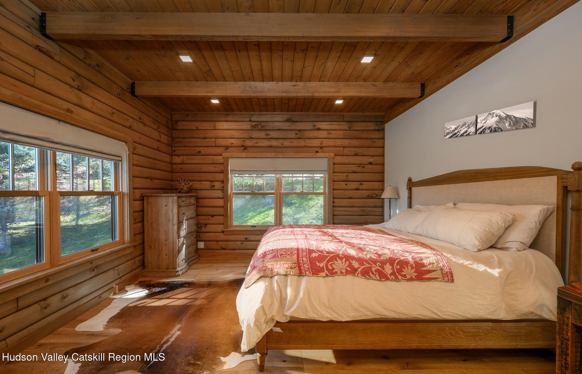 209 Club Road Windham, NY 12496 - Photo 9 of 18 a bedroom with a large bed and a large window