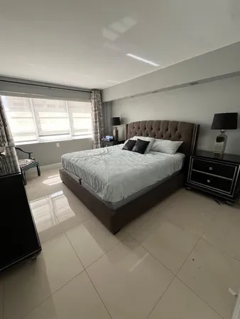 a bedroom with a bed and a couch