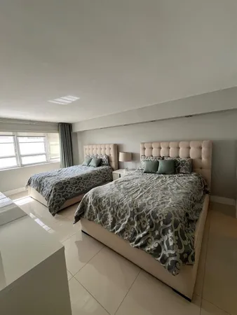 a bedroom with two beds and a window