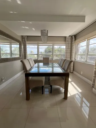 a dining room with furniture and window