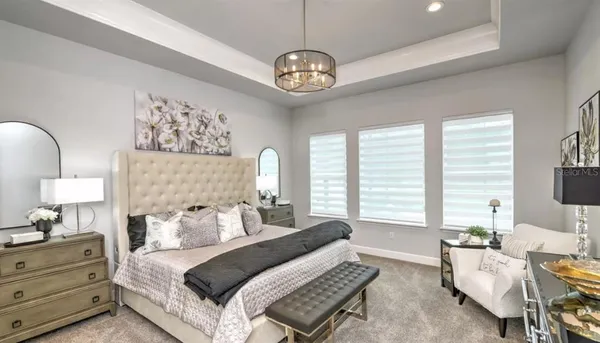 a bedroom with a bed and dresser with mirror