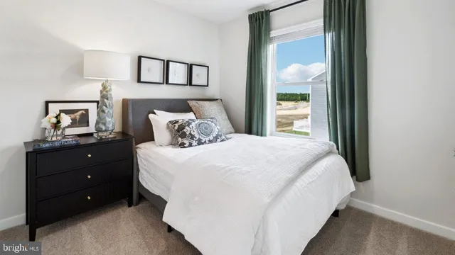 a bedroom with a bed and painting on the wall