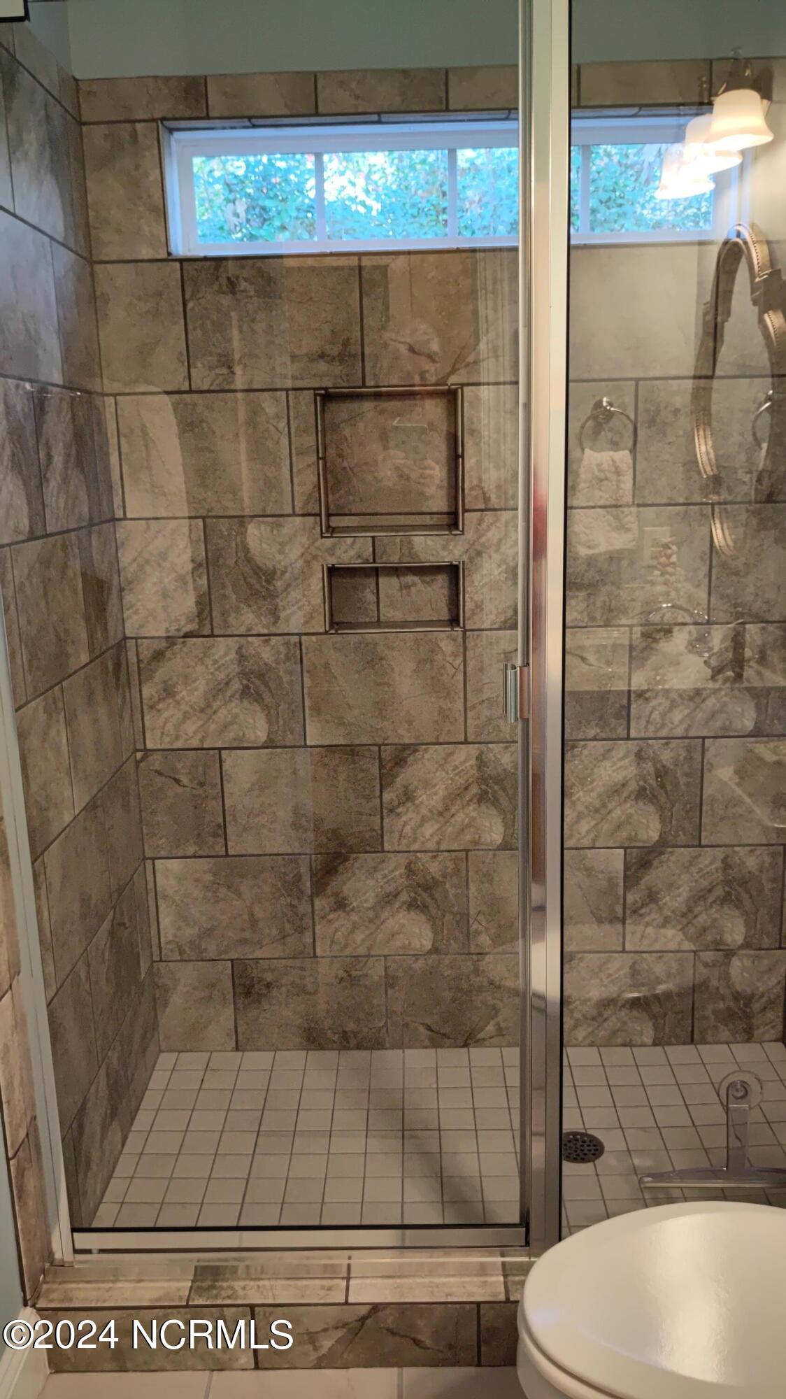 114 Ransey Court Hampstead, NC 28443 - Photo 35 of 48 Both Full Baths have a tiled Shower; Master bath has a large Soaking Tub.