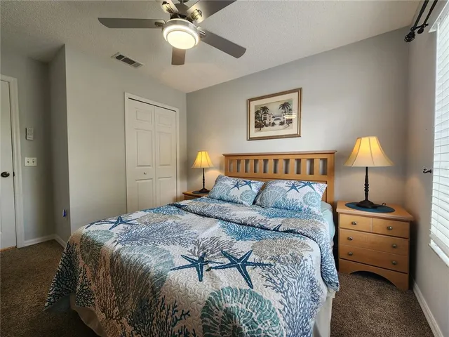 a bedroom with a bed and a lamp