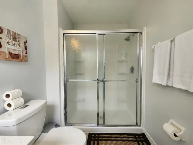 a bathroom with a shower and toilet