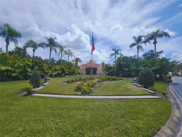 a view of a house with a swimming pool and a yard