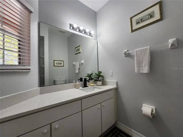 a bathroom with a sink and mirror