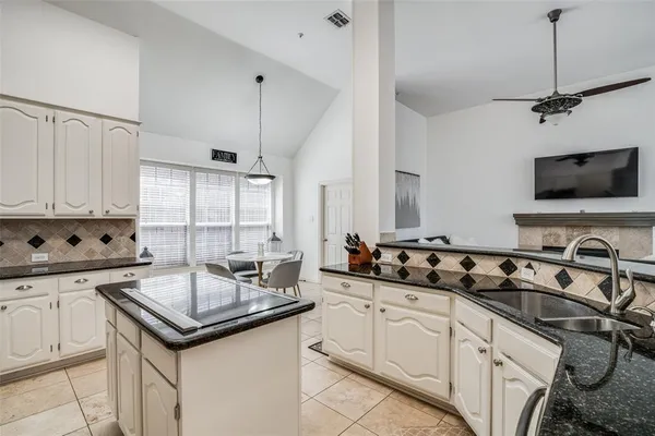 a kitchen with a sink stove and cabinets